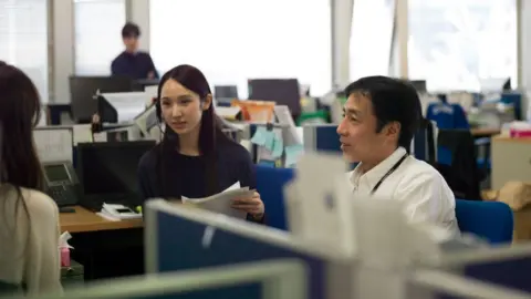 Japanese office workers having a meeting