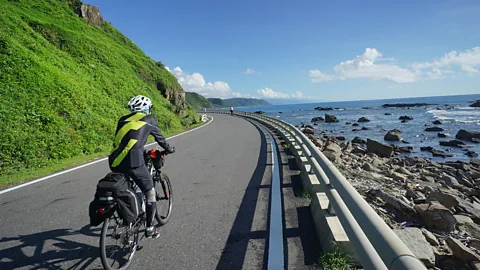 Cyclist on coastal road in Taiwan Kenting National Park